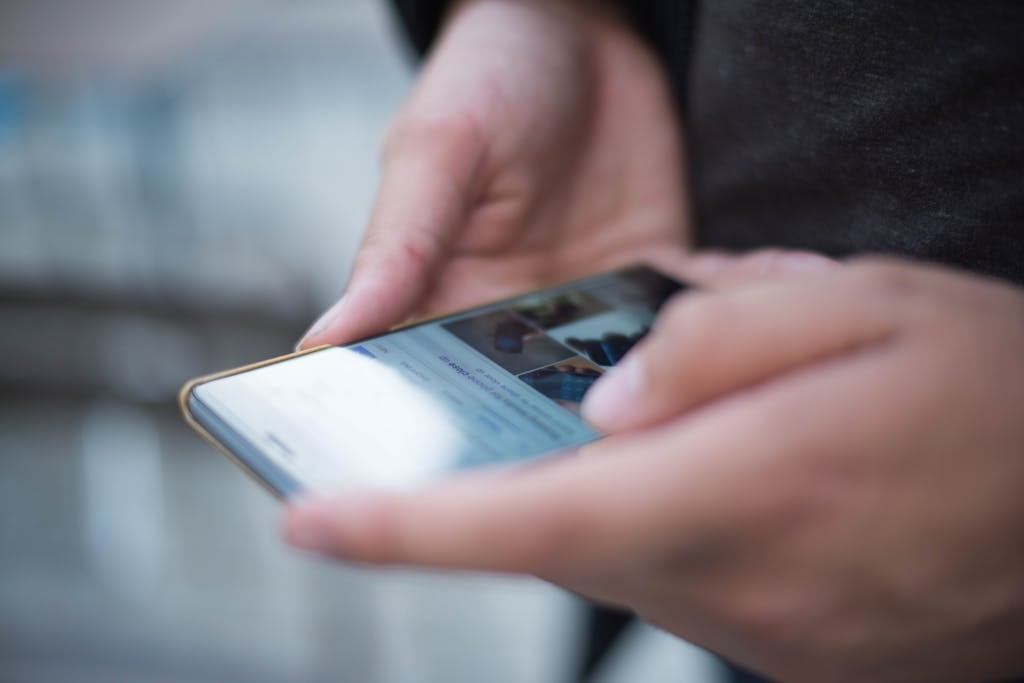 Person Using Smartphone Shallow Focus Photography